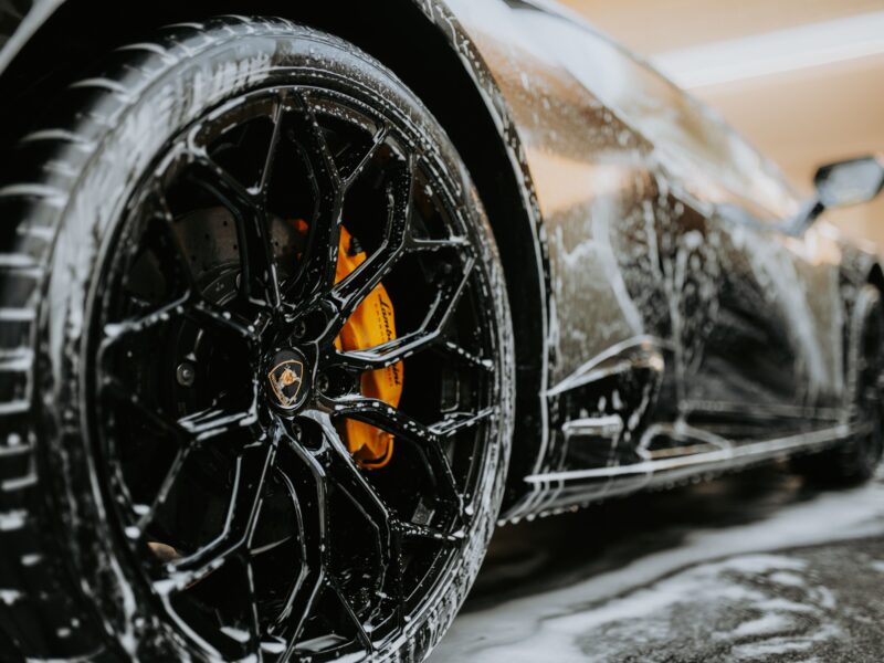 Close-up of professional wheel and tire detailing during car cleaning service in Rawalpindi
